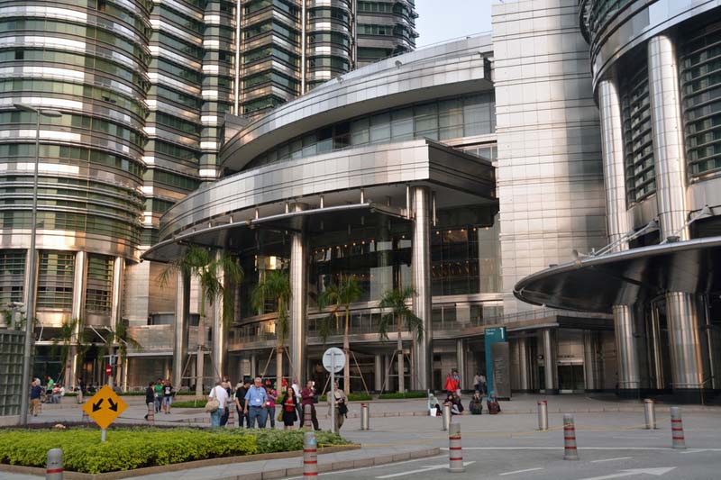 view from street of stainless steel curvilinear building with people in foreground