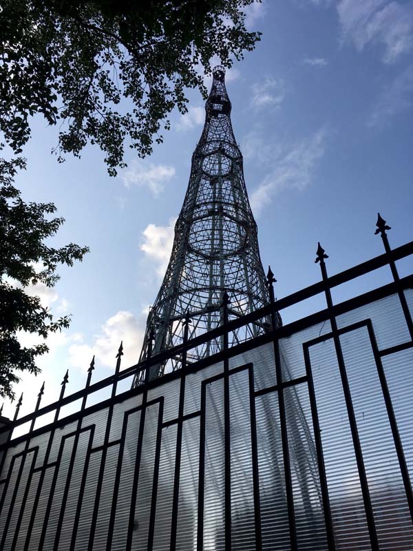 metal radio tower behind fence
