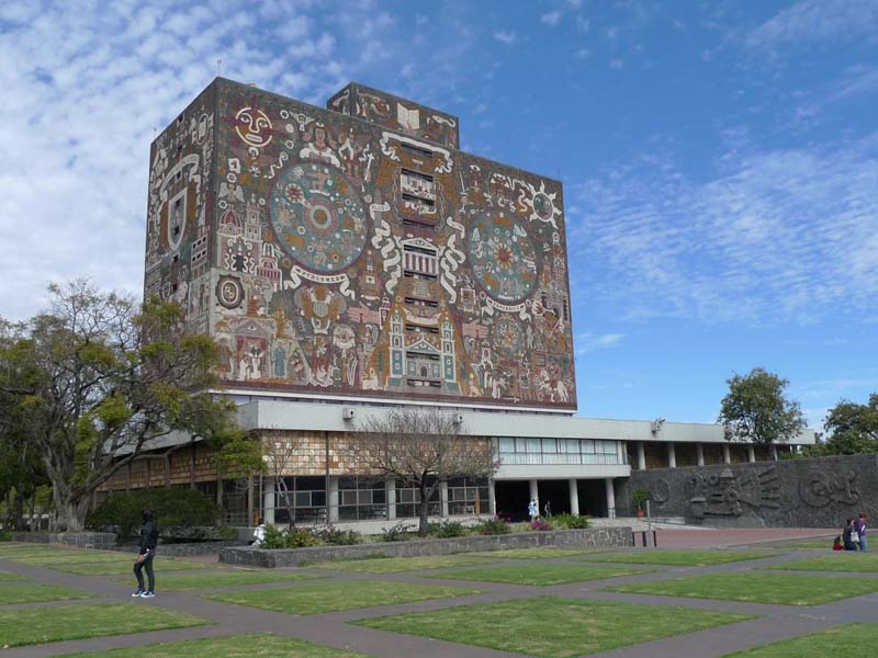 modernist building with Aztec-style murals