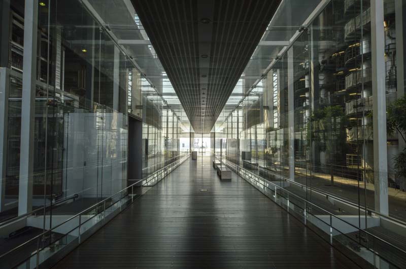 view down corridor of glass and steel walls