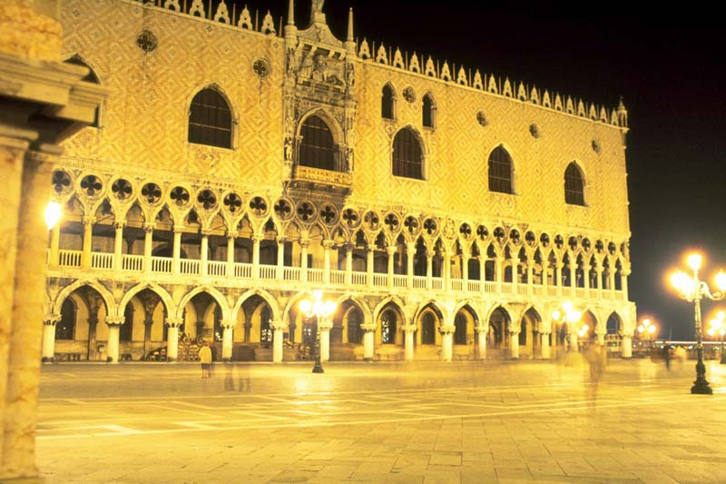 Venetian Gothic building and plaza at night