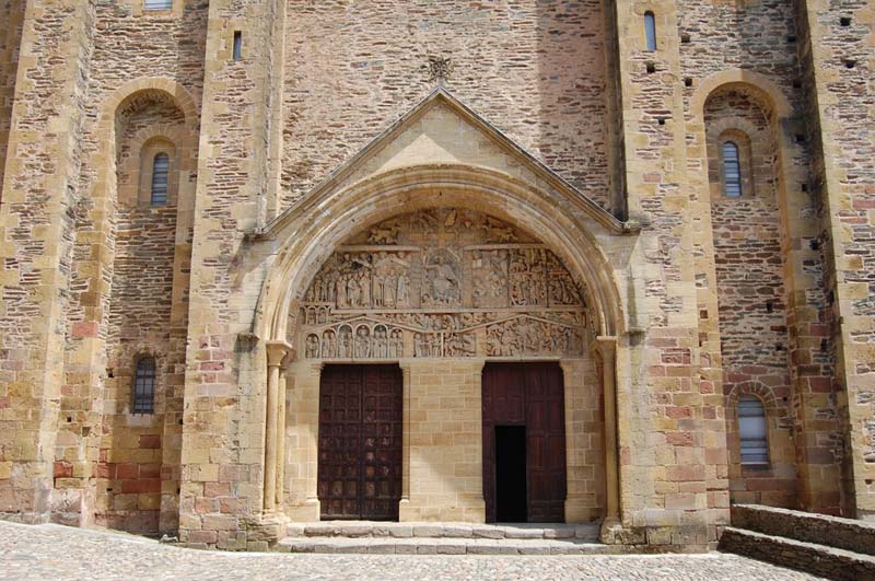 stone church with arched entrance with tympanum