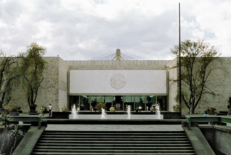 exterior of brick building with stairs and fountains