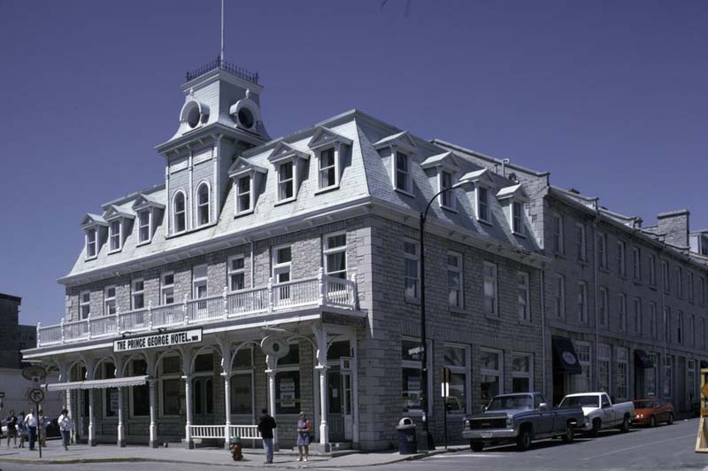 Prince George Hotel A long white building with mansard roof