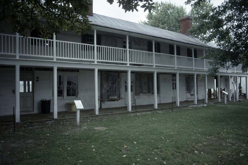 Rice’s Hotel a long, white, two-story building with external breezeways