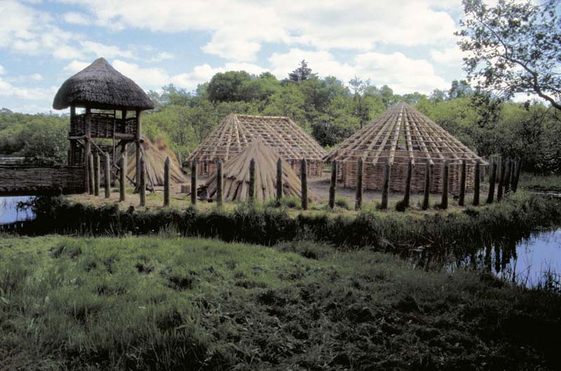 wood framed structures surrounded by moat